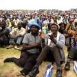 Miners gather at Wonderkop stadium outside the Lonmin mine in Rustenburg, northwest of Johannesburg in this January 30, 2014 file photo.  REUTERS/Siphiwe Sibeko/Files
