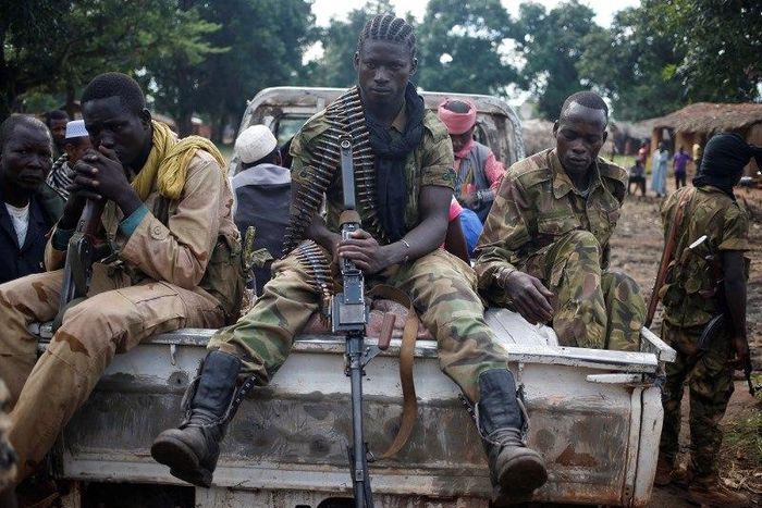 Seleka fighters take a break as they sit on a pick-up truck in the town of Goya June 11, 2014. 
REUTERS/Goran Tomasevic