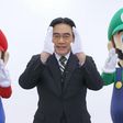 Late Nintendo CEO, Satoru Iwata with the Mario brothers in a commercial.
