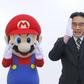 Late Nintendo CEO, Satoru Iwata with the Mario brothers in a commercial.