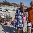 A tourist reacts after paying tribute at a makeshift memorial at the beachside of the Imperial Marhaba resort, which was attacked by a gunman in Sousse, Tunisia, June 29, 2015. REUTERS/Zohra Bensemra
