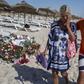 A tourist reacts after paying tribute at a makeshift memorial at the beachside of the Imperial Marhaba resort, which was attacked by a gunman in Sousse, Tunisia, June 29, 2015. REUTERS/Zohra Bensemra