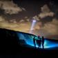 French gendarmes patrol while a police helicopter flies over the beach of Oye-Plage, near Calais, northern France, as they try to intercept migrants attempting to cross the Channel