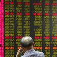 A man watches a board showing stock prices at a brokerage office in Beijing, China, July 6, 2015.   REUTERS/Kim Kyung-Hoon