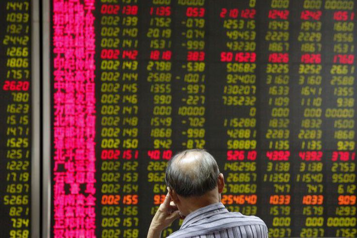 A man watches a board showing stock prices at a brokerage office in Beijing, China, July 6, 2015.   REUTERS/Kim Kyung-Hoon