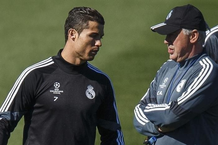 Real Madrid's coach Carlo Ancelotti (R) stands next to Cristiano Ronaldo during their training session at Valdebebas sports ground in Madrid March 9, 2015.