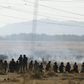 Policemen fire at striking miners outside a South African mine in Rustenburg, 100 km (62 miles) northwest of Johannesburg, August 16, 2012.