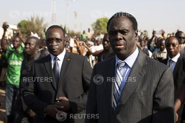 Burkina Faso President Michel Kafondo (R) and Prime Minister Isaac Zida (L) arrive at a memorial service for six people who died during the recent popular uprising in Ouagadougou, December 2, 2014.  REUTERS/Joe Penney