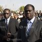 Burkina Faso President Michel Kafondo (R) and Prime Minister Isaac Zida (L) arrive at a memorial service for six people who died during the recent popular uprising in Ouagadougou, December 2, 2014.  REUTERS/Joe Penney