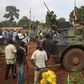 Men stand facing French soldiers as they block a road which French army vehicles were travelling on, during a protest in Bambari May 22, 2014. REUTERS/Goran Tomasevic