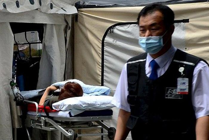 A woman, who is believed to be infected with Middle East Respiratory Syndrome (MERS), lies on a stretcher in a quarantine area set up in a hospital in Seoul, South Korea.