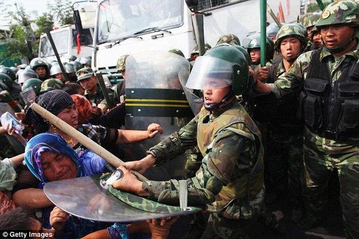 Chinese police clash with Uighurs during a protest in Urumqi, the capital of Xinjiang Uighur autonomous region in 2009. A gang of Uighurs attacked a police checkpoint in the southern city of Kashgar this week in apparent revenge for the government's cr...