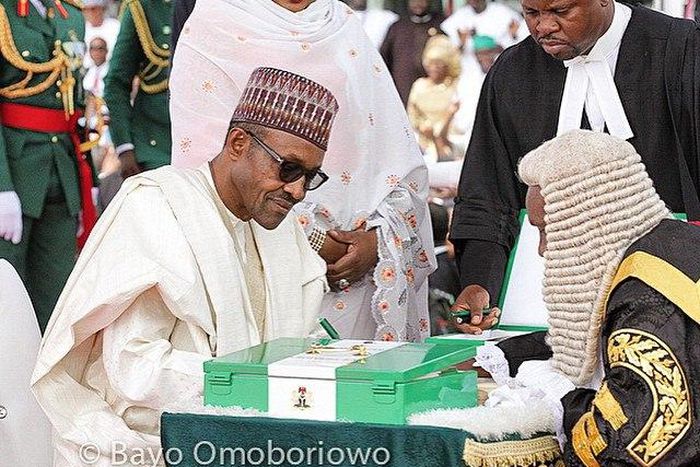 Muhammadu Buhari taking his oath of office on Friday, May 29, in company of his wife and legal luminaries.