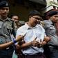 Wa Lone (C, pictured after an August court appearance) and fellow reporter Kyaw Soe Oo have already spent more than a year behind bars