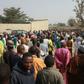 People walk in the streets of the Sajeri village on the outskirts of the Borno state capital, Maiduguri, on January 8, 2019 as they gather for the funerals of the victims of an attack the day before