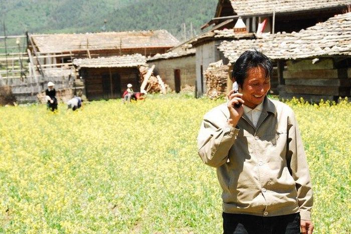 A Chines man making a phone call.