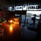 A shopkeeper waits for customers in his candlelit  fast food store during a load shedding electricity blackout in Cape Town April 15, 2015.       REUTERS/Mike Hutchings