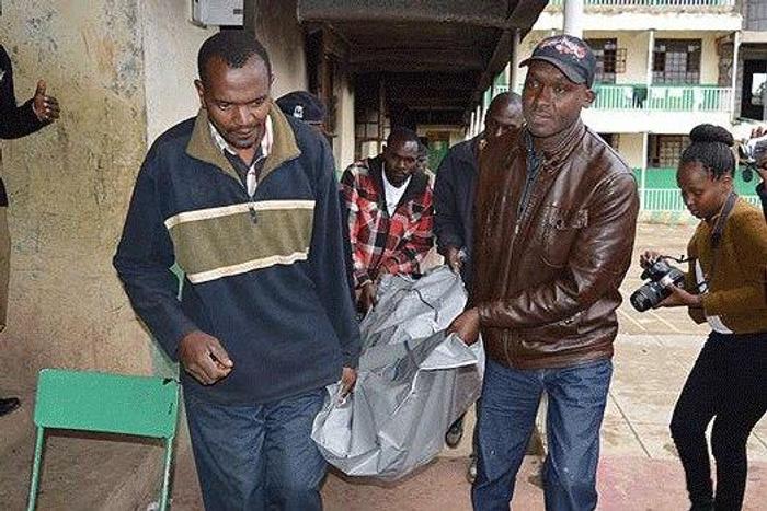 The bodies of the victims being carried out of what remains of the dormitory