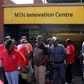 Police officers keep watch during a strike of MTN workers outside the company's headquarters in Johannesburg May 20, 2015. REUTERS/Siphiwe Sibeko
