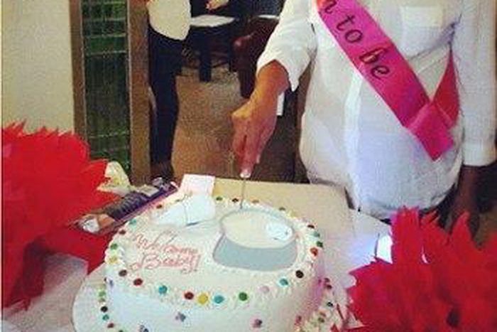Michelle Ashionye Raccah cutting her baby shower cake