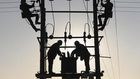 Labourers work on an electricity pylon in Huangni village of Chuzhou, Anhui province March 17, 2014. REUTERS/China Daily