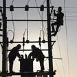 Labourers work on an electricity pylon in Huangni village of Chuzhou, Anhui province March 17, 2014. REUTERS/China Daily