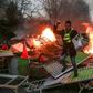 A yellow vest "Gilets Jaunes" anti-government protestor stands on a burning barricade in Paris on January 5 during clashes with security personnel