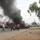 Soldiers stand near a burning barricade during demonstrations by protesters against the ruling CNDD-FDD party's decision to allow Burundian President Pierre Nkurunziza to run for a third five-year term in office, in Bujumbura, May 7, 2015. REUTERS/Jean...