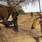 A fighter with the Tuareg separatist group MNLA (National Movement for the Liberation of Azawad) brandishes a separatist flag for the region they call Azawad outside the local regional assembly, where members of the rebel group met with the Malian army...