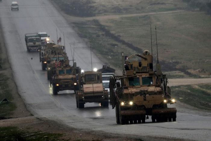 A US military convoy passes the flashpoint Syrian town of Manbij on December 30, 2018, part of a deployment the US-led anti-jihadist coalition says it has now begun withdrawing following a controversial decision by President Donald Trump last month