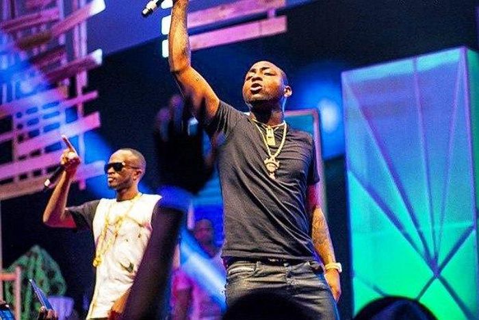 Davido and Danagog performing together at an event