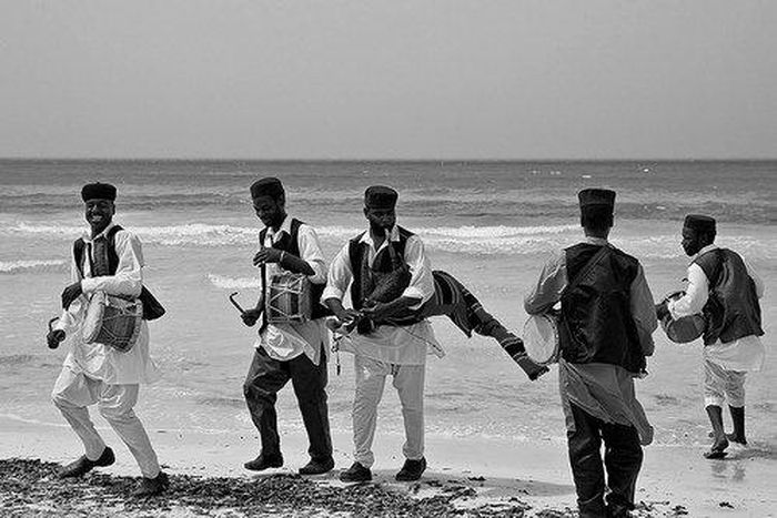 A band of musicians at a beach.