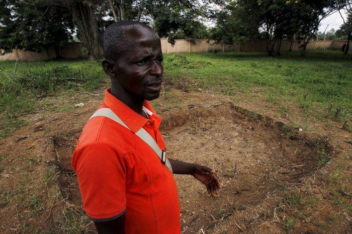 Yaboua Assie stands in the courtyard of the local government offices, near a rectangular depression in the earth that until recently was a mass grave containing the remains of 45 massacred civilians, in Blolequin, a small town in western Ivory Coast Ju...