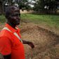 Yaboua Assie stands in the courtyard of the local government offices, near a rectangular depression in the earth that until recently was a mass grave containing the remains of 45 massacred civilians, in Blolequin, a small town in western Ivory Coast Ju...