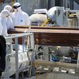 A coffin, containing the body of an unidentified migrant, is carried off the Irish Navy ship LE Niamh in the Sicilian harbour of Messina, Italy July 29, 2015.    REUTERS/Antonio Parrinello