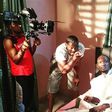 DJ Tee giving Funky Mallam instructions as the director of photography shoots a scene