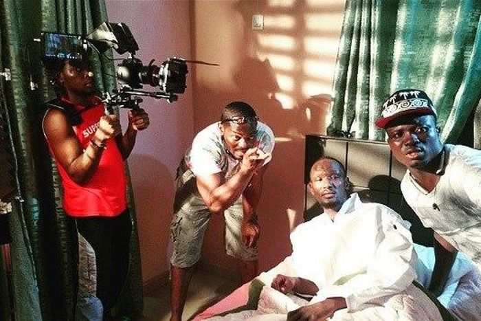 DJ Tee giving Funky Mallam instructions as the director of photography shoots a scene