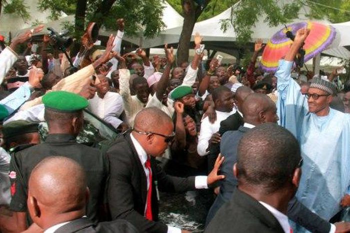 Excited youths surround President Muhammadu Buhari in Abuja on July 17, 2015.