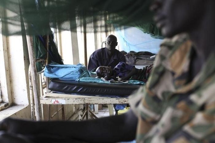 A child sick with malaria and from malnutrition lies on a bed in a hospital in Bor March 15, 2014. REUTERS/Andreea Campeanu