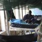 A child sick with malaria and from malnutrition lies on a bed in a hospital in Bor March 15, 2014. REUTERS/Andreea Campeanu