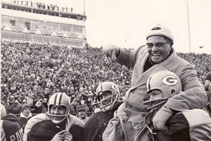 Coach Vince Lomardi being carried by his Green Bay Packers players after winning an NFL championship