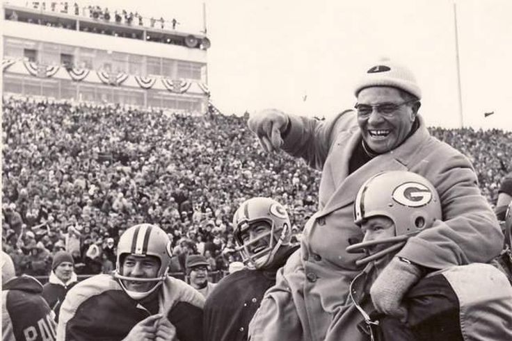 Coach Vince Lomardi being carried by his Green Bay Packers players after winning an NFL championship