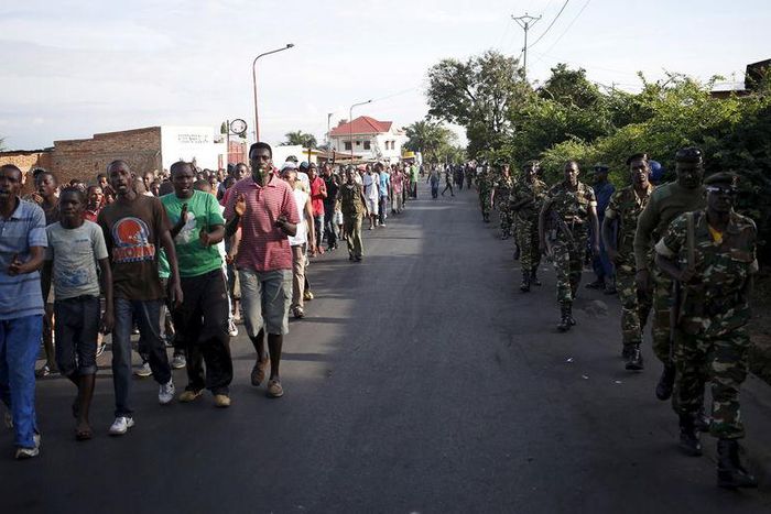 Protesters (L), escorted by soldiers (R), march during a demonstration against President Pierre Nkurunziza along a street in Bujumbura, Burundi, May 11, 2015.    REUTERS/Goran Tomasevic