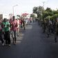 Protesters (L), escorted by soldiers (R), march during a demonstration against President Pierre Nkurunziza along a street in Bujumbura, Burundi, May 11, 2015.    REUTERS/Goran Tomasevic