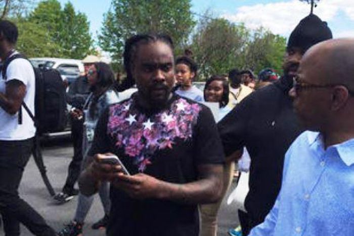 Wale discussing with residents of Baltimore