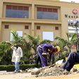 Construction workers dig holes to erect barriers at the reopened Westgate shopping mall, which was closed in the aftermath of an attack by militant gunmen in September 2013 that killed 67 people and injured many more, in capital Nairobi July 14, 2015. ...