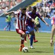 Atletico Madrid's Arda Turan (L) and Levante's Kalu Uche fight for the ball during their Spanish first division soccer match at the Ciudad de Valencia stadium in Valencia, Spain, May 10, 2015. REUTERS/Heino Kalis