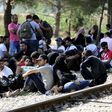 Migrants wait on the Greek side of the border to enter Macedonia near Gevgelija, Macedonia, en route to northern Europe, July 20, 2015.    REUTERS/Ognen Teofilovski