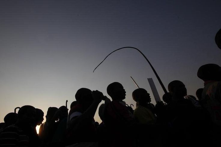 Striking platinum mineworkers gather for a report back on negotiations at Lonmin's Marikana mine in South Africa's North West Province, August 29, 2012.    REUTERS/Mike Hutchings