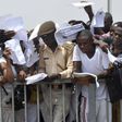 Job-seekers lie on the pitch after a stampede in Abuja National Stadium during the Nigerian immigration recruitment in 2014.